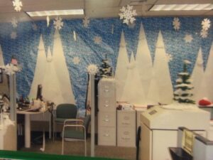 Office with blue backdrop with white mountains and snowflakes in air